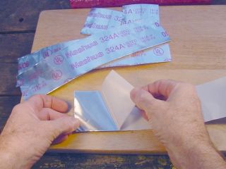 Peel backing from one strip of tape